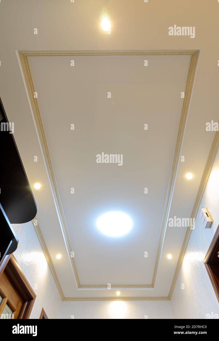 Original stylish multilevel ceiling in the hallway of the apartment