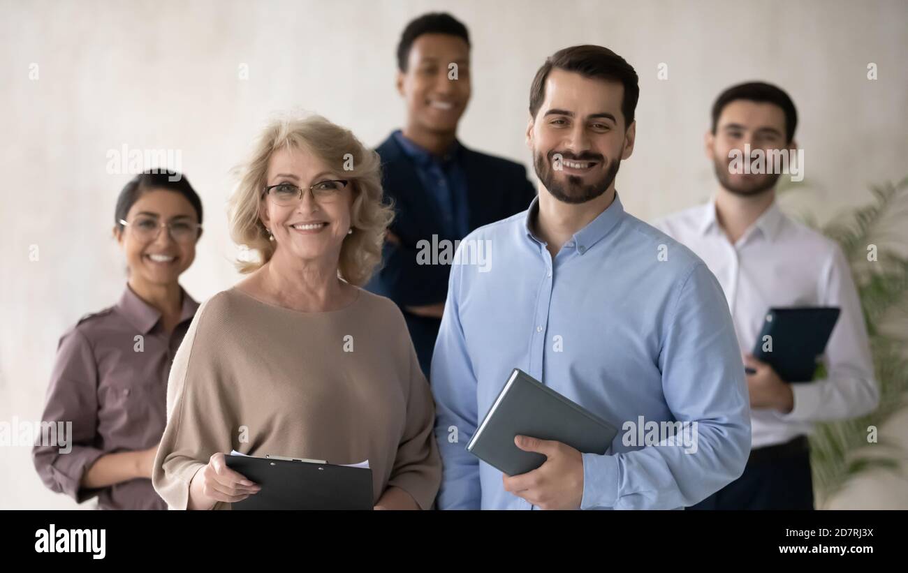Portrait of smiling diverse businesspeople posing at workplace Stock Photo