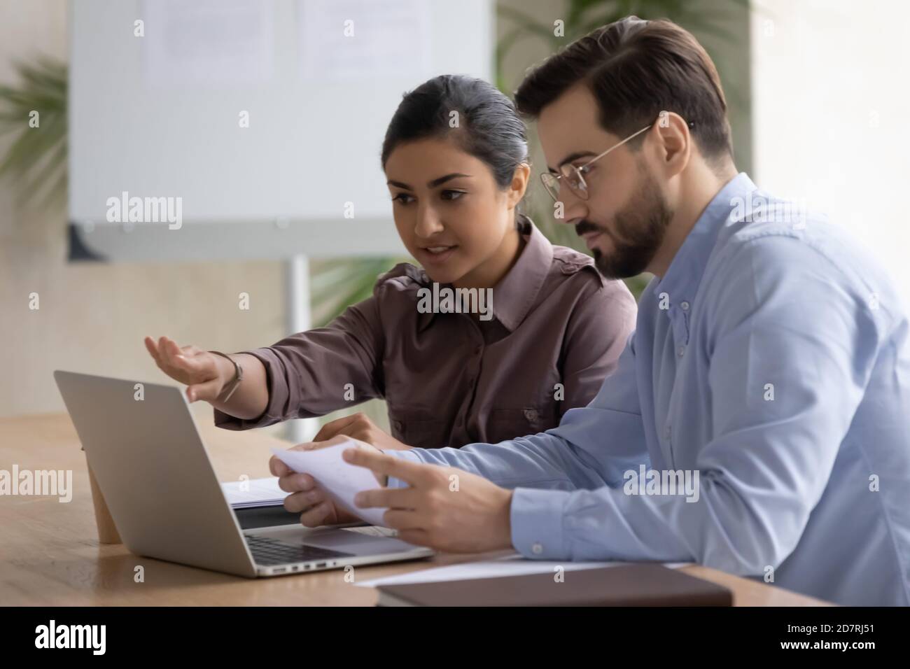 Diverse businesspeople work on laptop brainstorming in office Stock ...