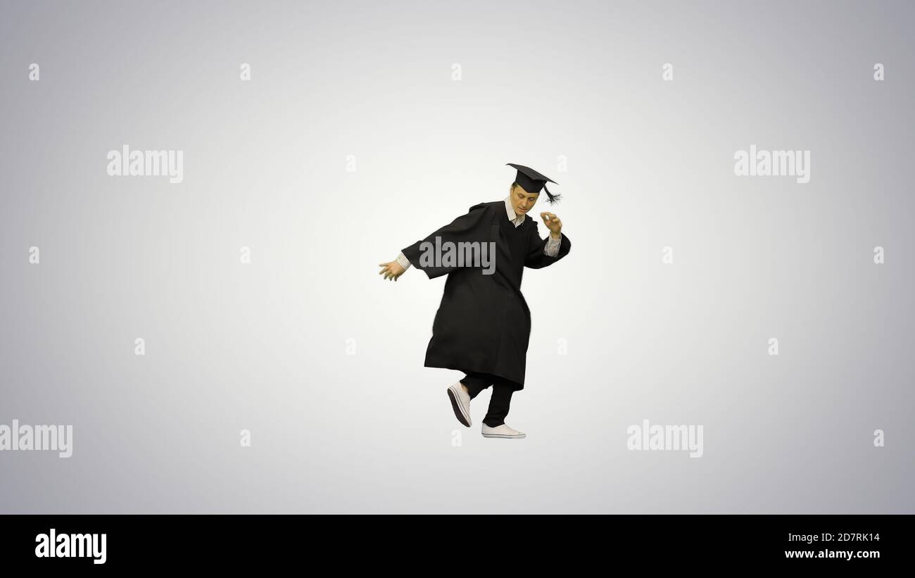 Male graduate in robe and mortarboard doing modern dance and bre Stock Photo