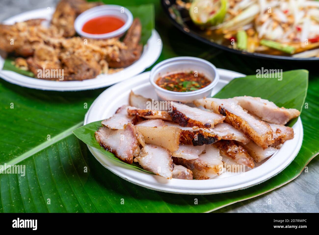 Street food Grilled Pork Neck, Grilled Pork With Spicy sauce is one of the  most popular Thai dishes. Thai Food Stock Photo - Alamy