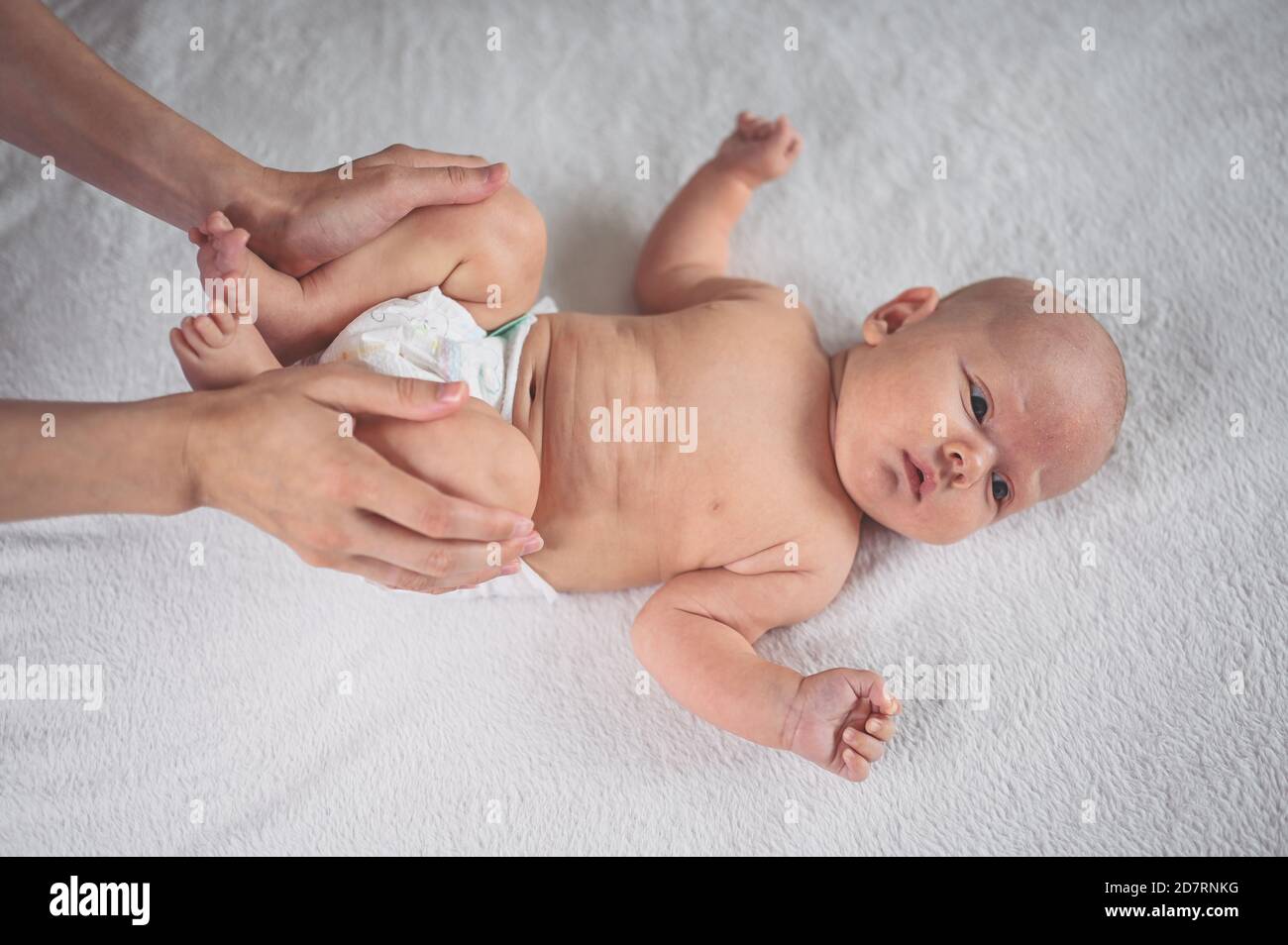 Mom is changing diaper cute emotional funny newborn little baby boy