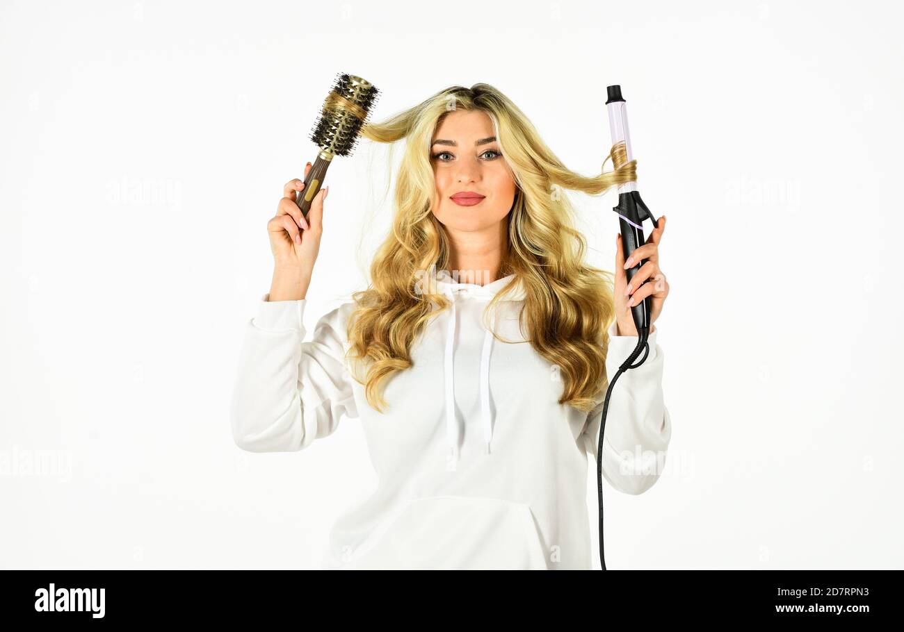 Create hairstyle. Woman with long curly hair use curling iron. Hairdresser tips. Using different wrapping techniques. Online shop. Choose right type curling iron for your needs. Girl adorable blonde S...
