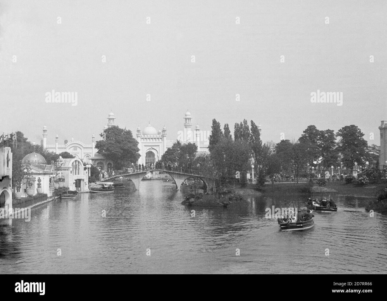 An old photograph, c.1924, of The British Empire Exhibition held at Wembley Park, Wembley, England, UK from 23.04.1924 to 31.10.1925. This view looks down the boating lake towards the Indian Pavilion. The main building material used for the buildings was reinforced concrete, (‘ferro-concrete’), selected for its speed of construction. Wembley Park earned the title of the first ‘concrete city’. The Indian pavilion had towers and domes in the style of the Taj Mahal. For economic and political reasons, the Indian Government did not take part in the 1925 season. Stock Photo
