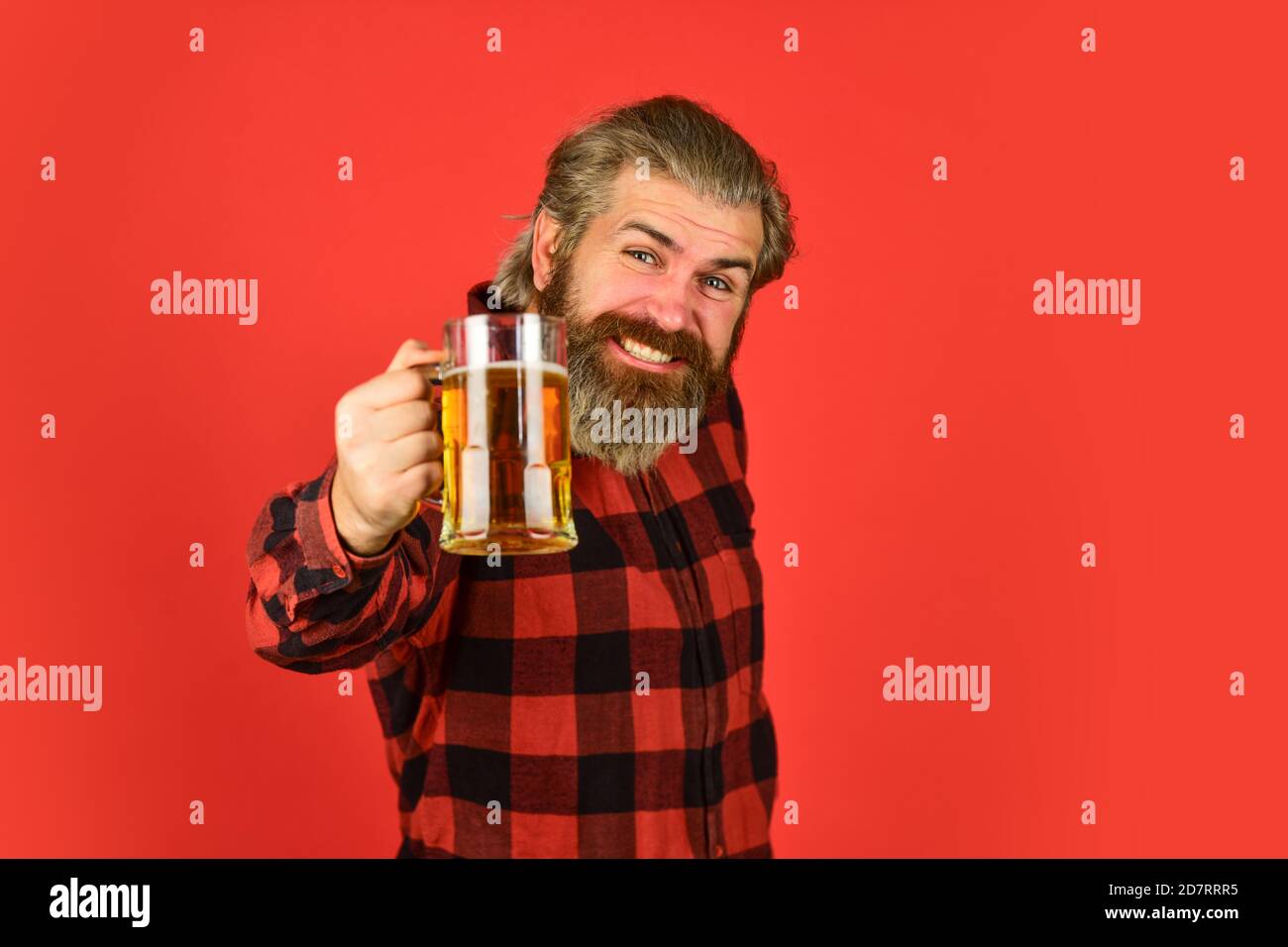 Beer festival. recreation. Man hold glass of beer. hipster at bar counter. having fun watching football. Brutal bearded male drinks beer from glass. Beer pub. Stylish bartender or barman in bar. Stock Photo
