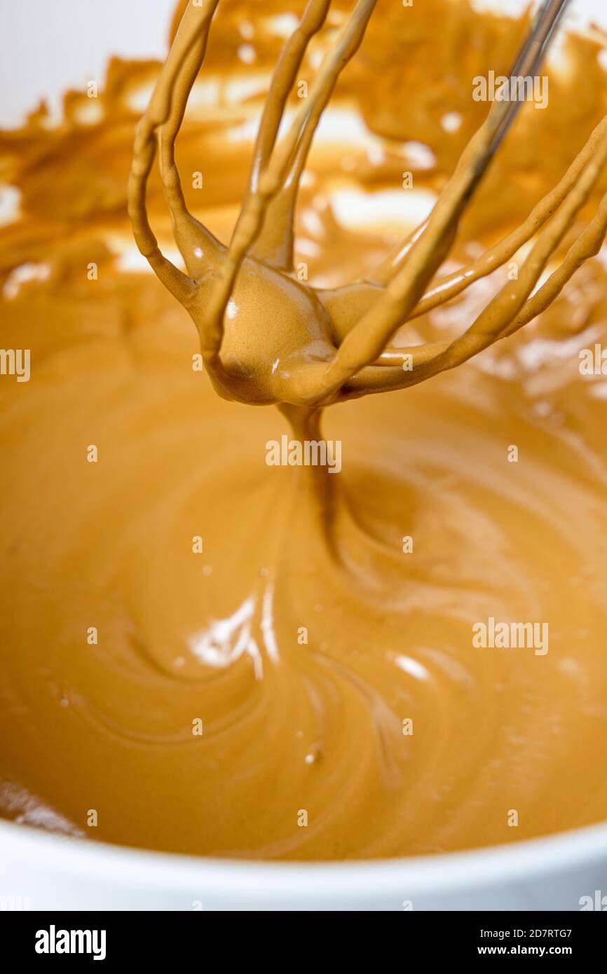 Wire whisk with whipped cream. Dalgona coffee preparation Stock Photo