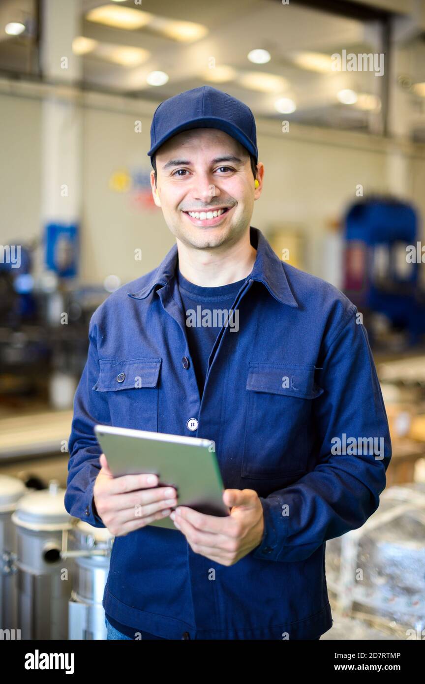 Portrait af an engineer using a tablet in a facility Stock Photo