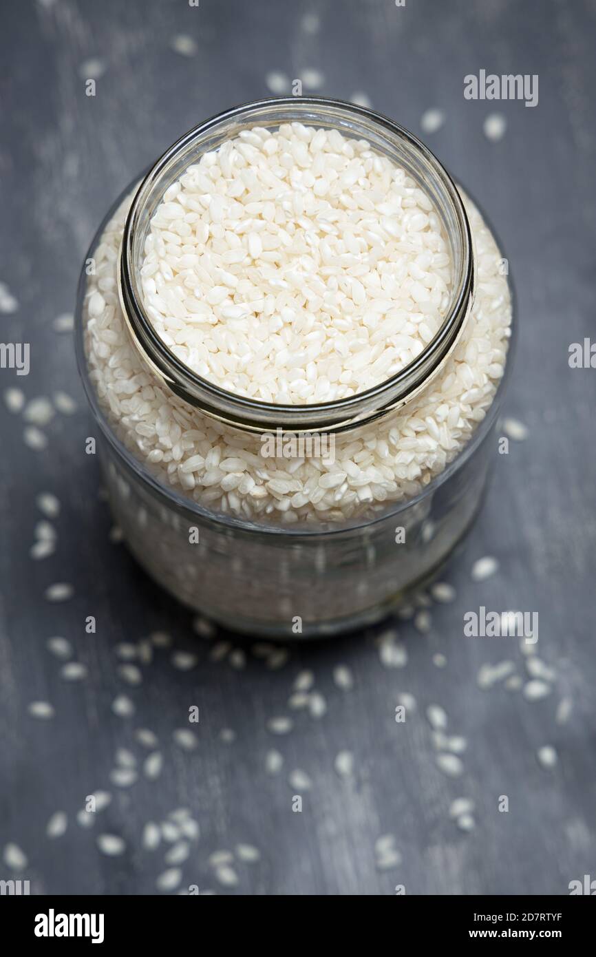 Big glass jar full of rice placed on a tabletop. Eco friendly concept