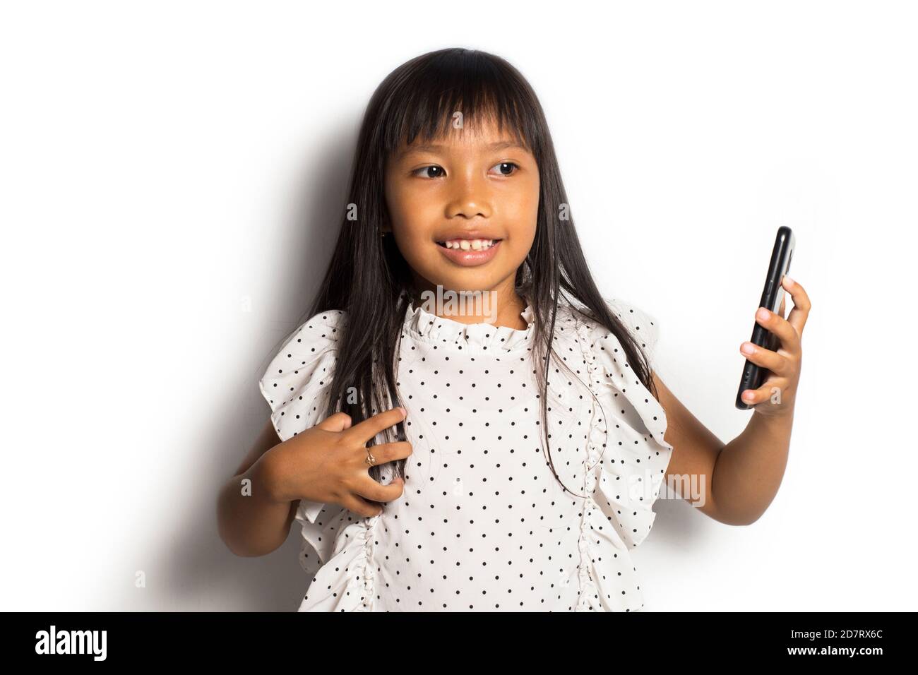 Happy asian little girl using smart phone on white background Stock ...