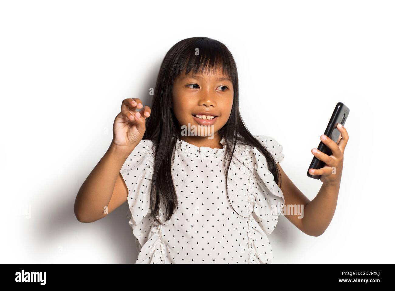 Happy asian little girl using smart phone on white background Stock ...