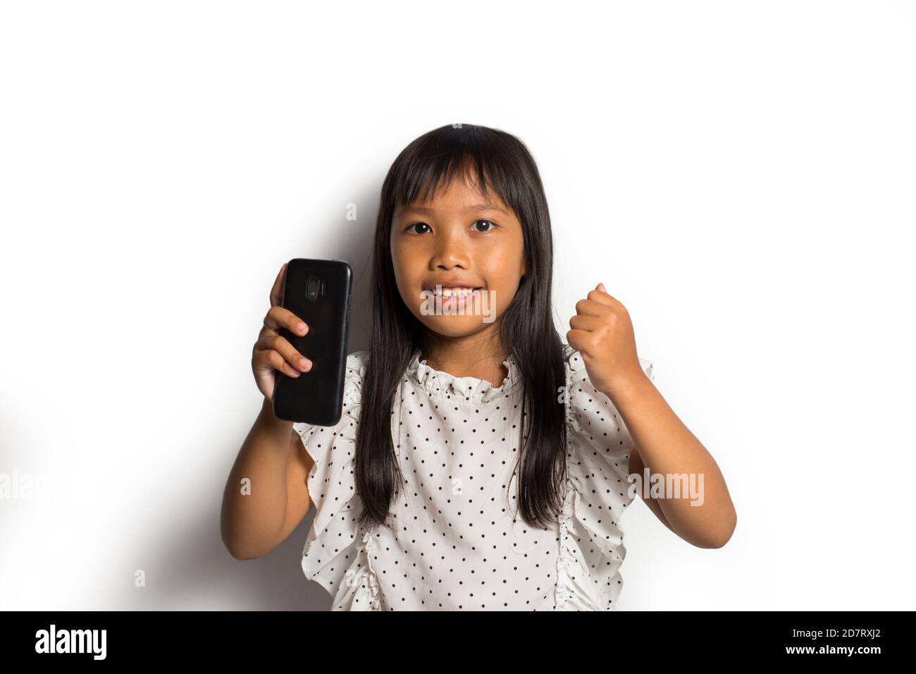 Happy asian little girl using smart phone on white background Stock ...