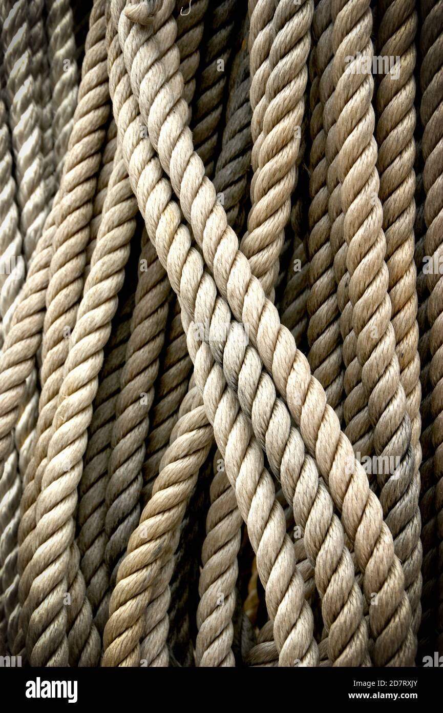 Coiled craft navy rope in seaport Stock Photo - Alamy