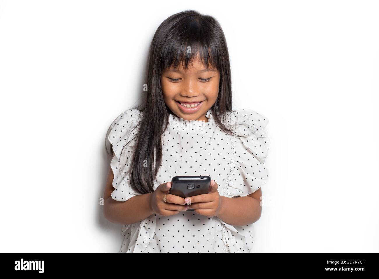 Happy asian little girl using smart phone on white background Stock ...