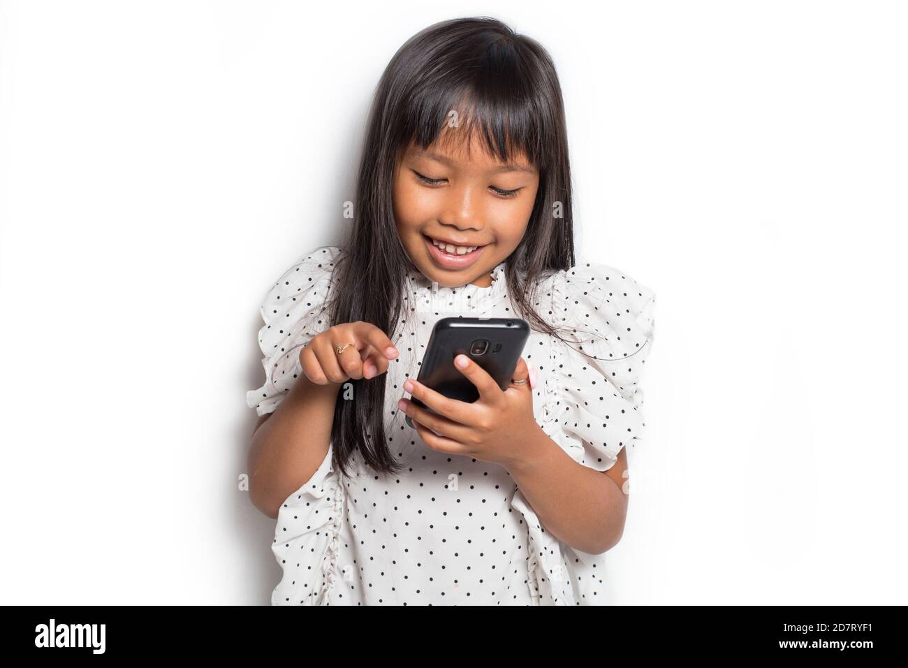 Happy asian little girl using smart phone on white background Stock ...