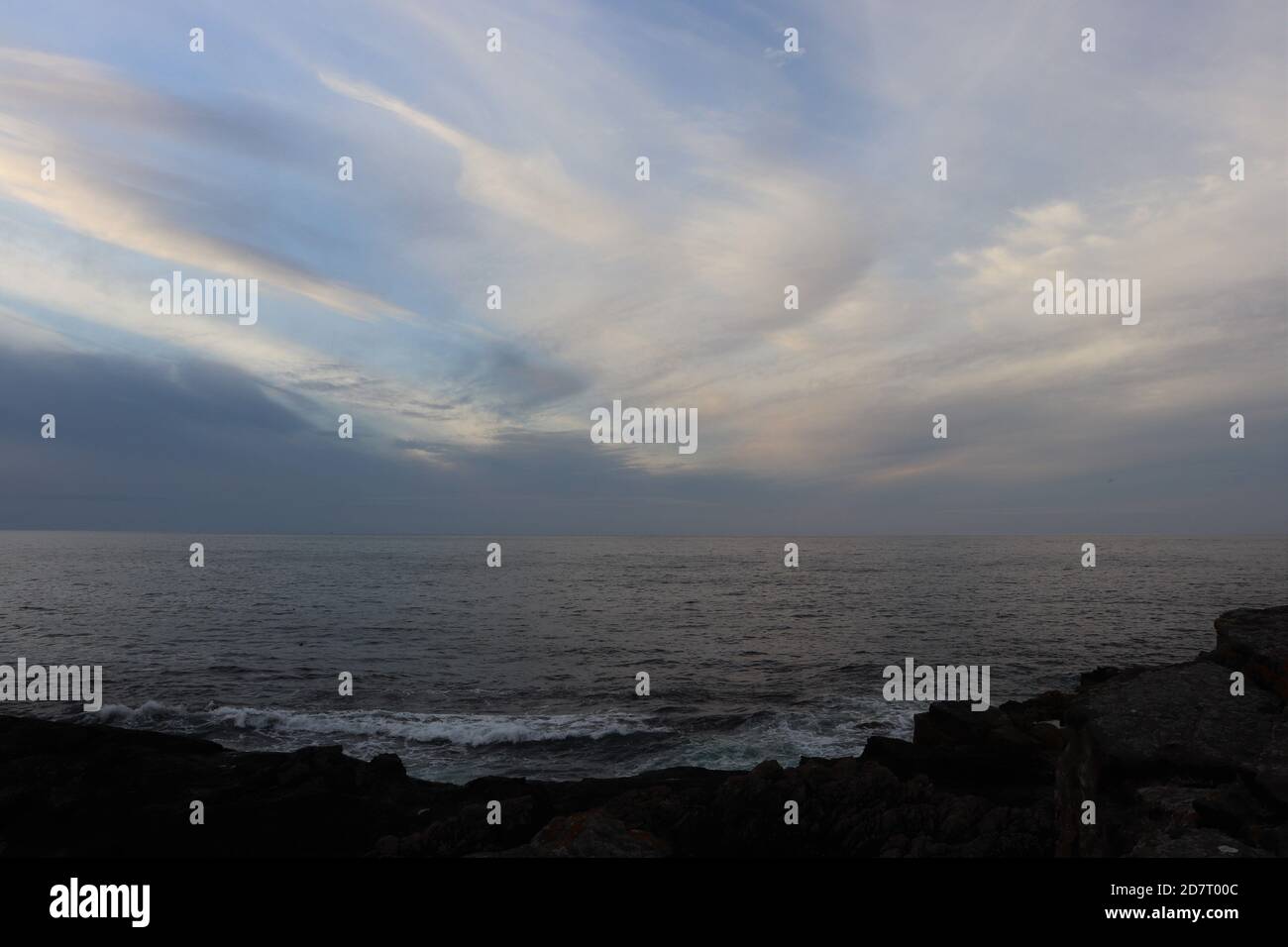 Twilight sky over sea and silhouettes of land Stock Photo - Alamy