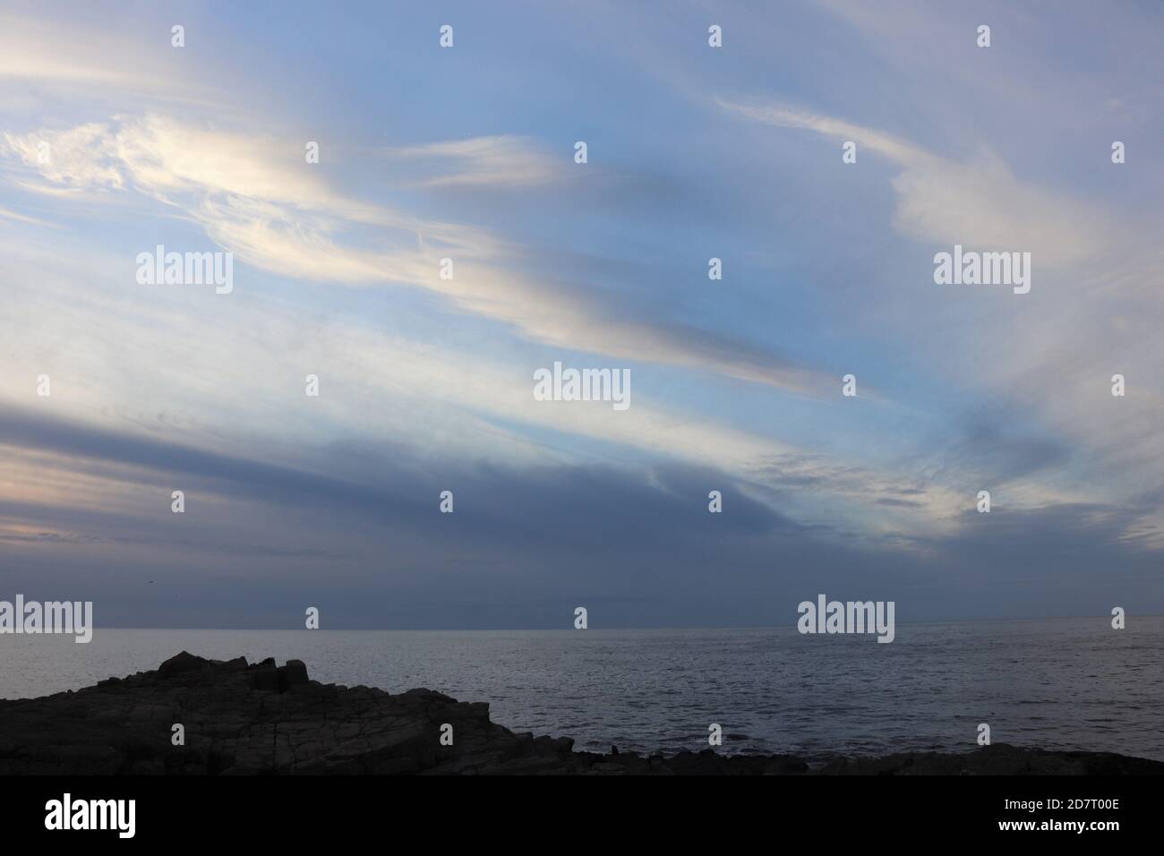 Twilight sky over sea and silhouettes of land Stock Photo - Alamy