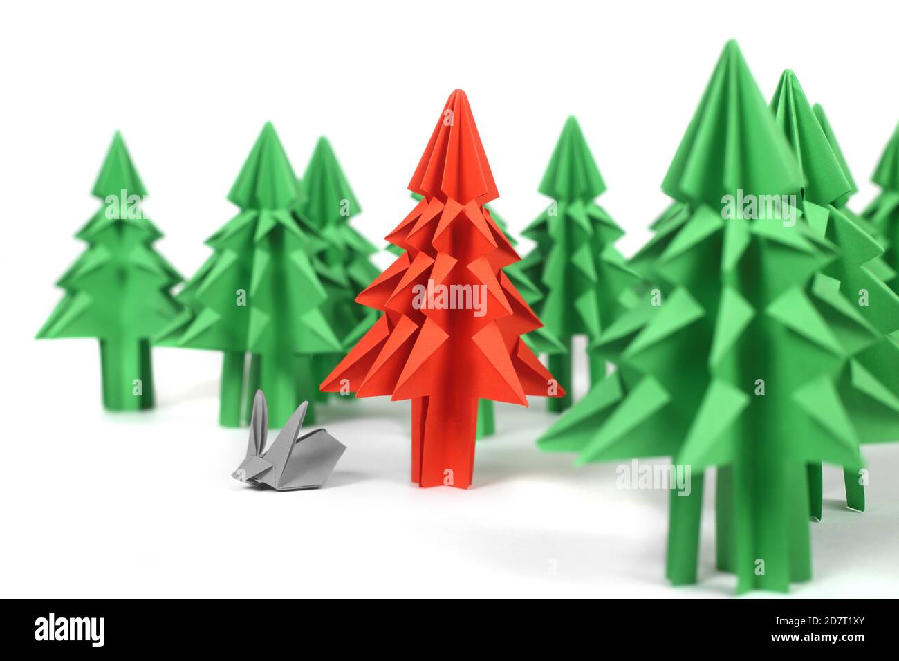 Origami Christmas trees of green craft paper isolated on white
