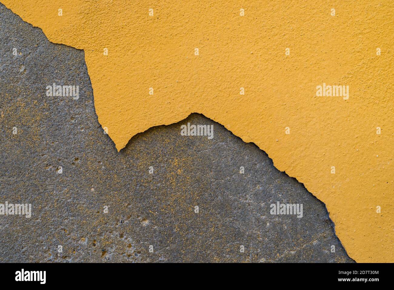 Paint peeling off the plastered wall. The building needs repair Stock