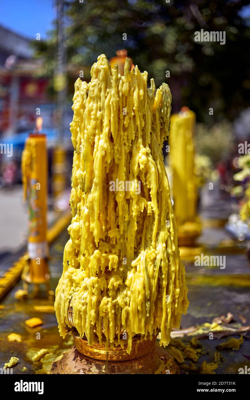 Candle harden wax drips of candles melting. Yellow candle Stock Photo