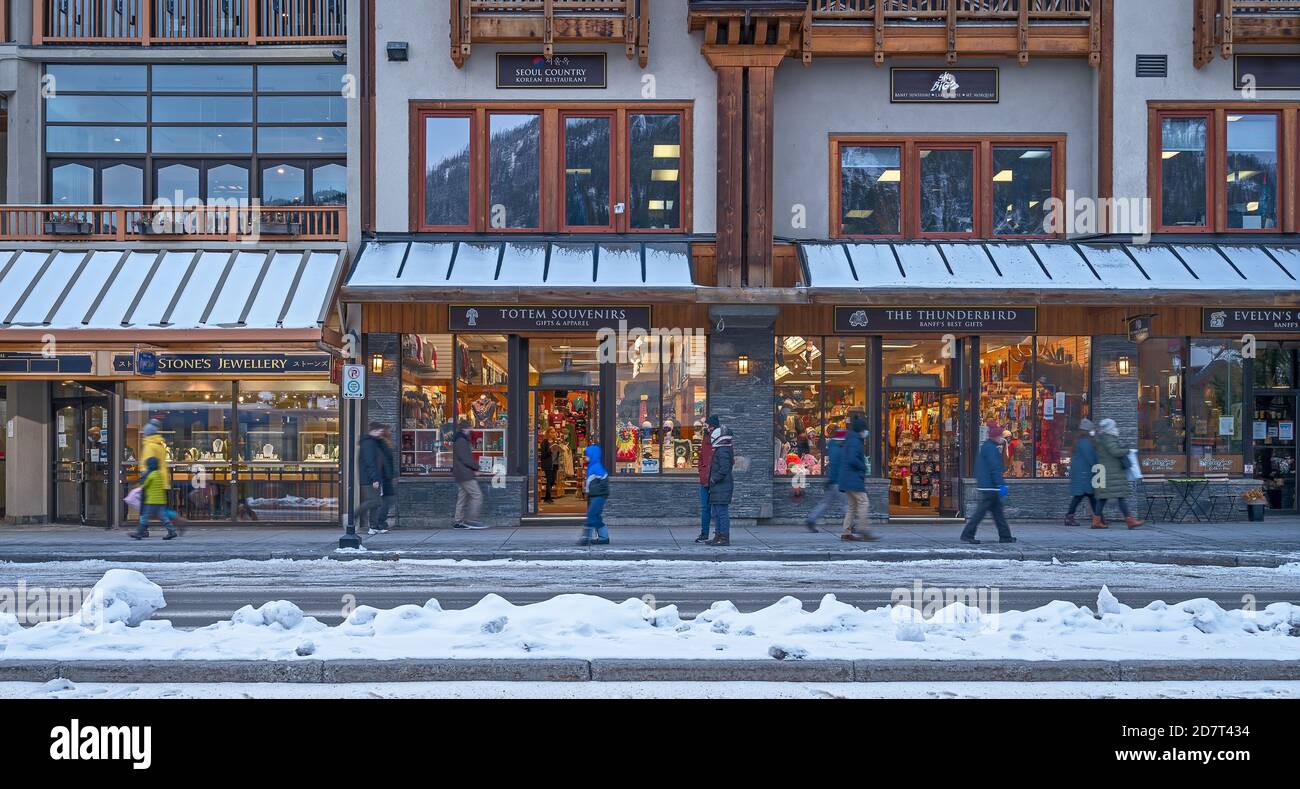 Banff, Alberta, Canada – October 24, 2020:  Evening view of pedestrians and shops on Banff Avenue Stock Photo