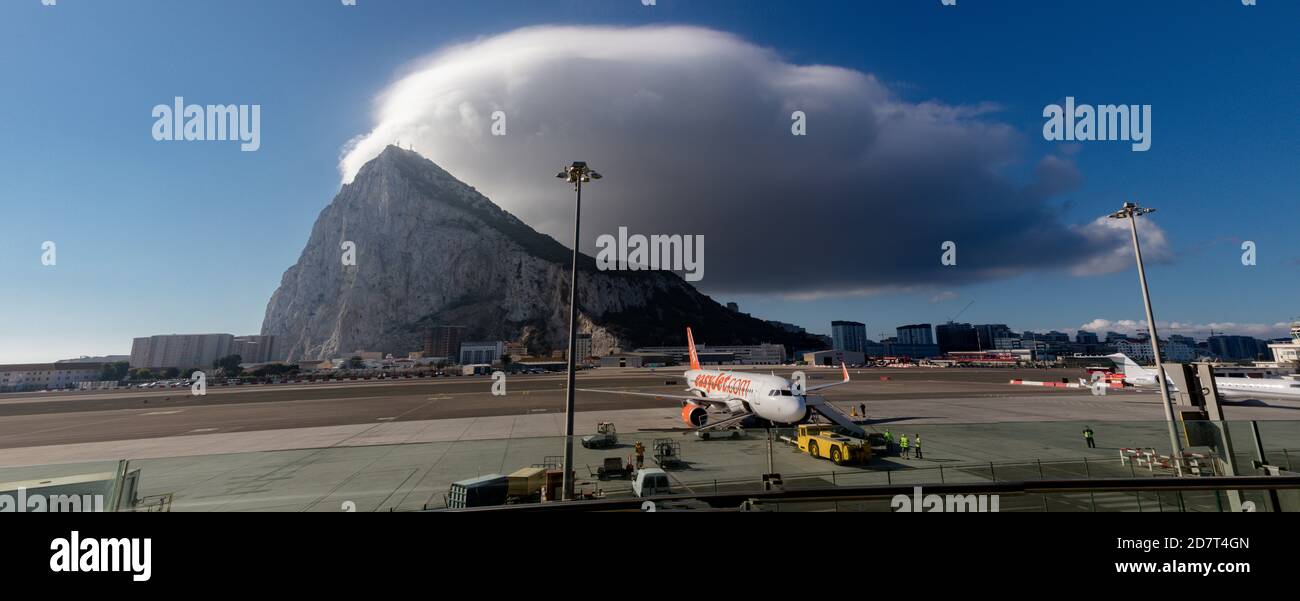 Gibraltar, United Kingdom, 3rd October 2018:- A cloud forms over the Rock of Gibraltar seen from the airport. Gibraltar is a British Overseas Territor Stock Photo