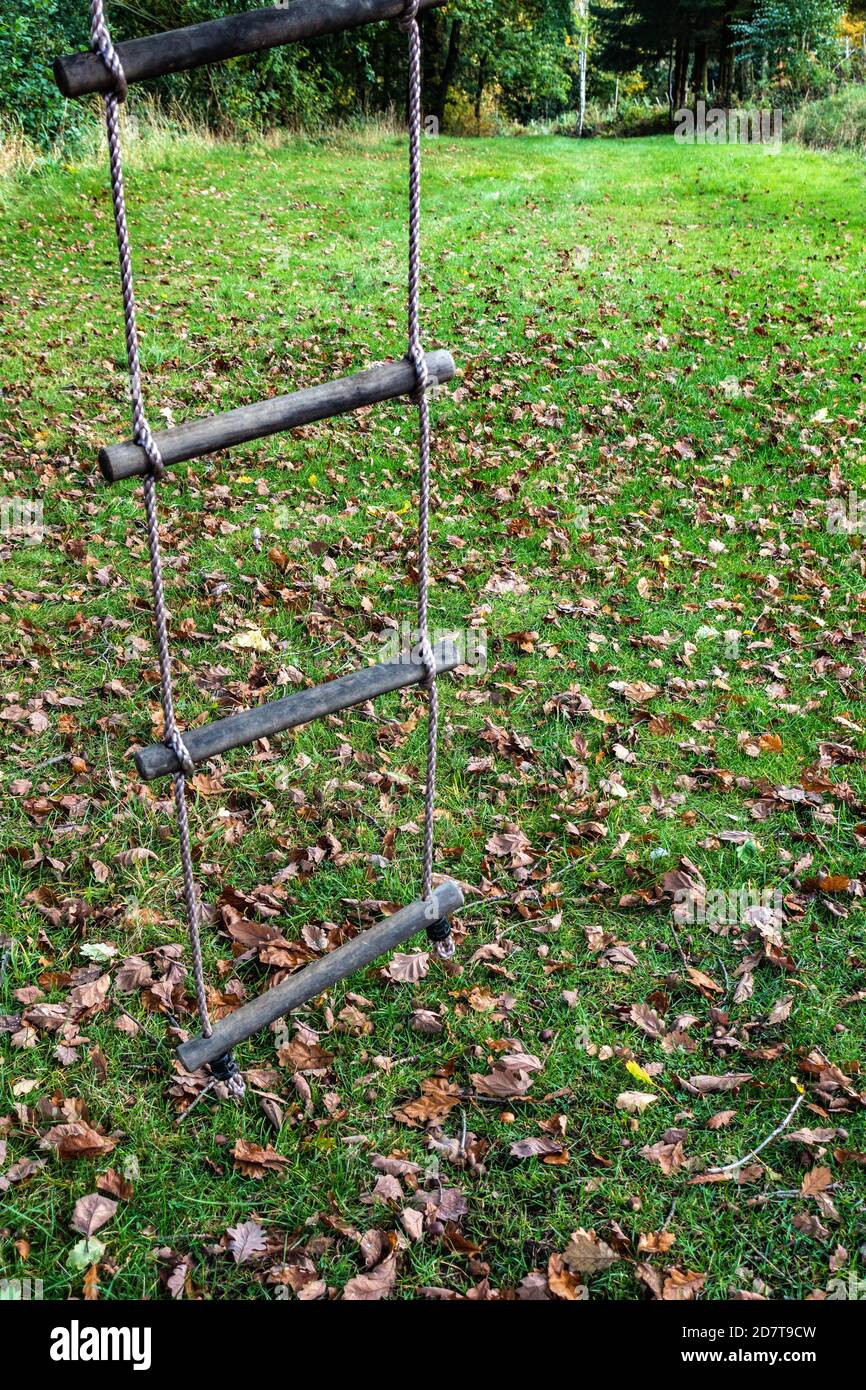 Childs rope ladder hanging from a tree in an English country garden ...