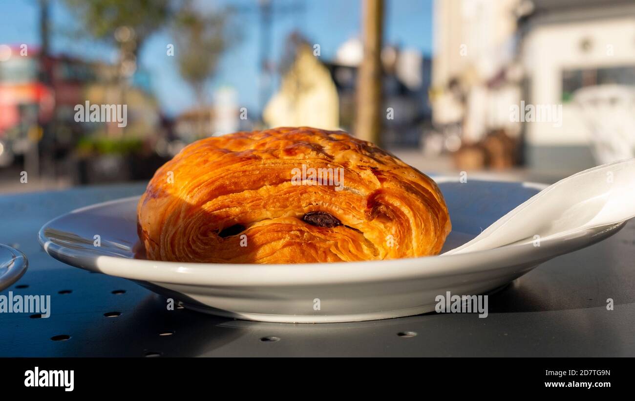 Pain au Chocolate pastry on a plate at an outside street cafe Stock Photo