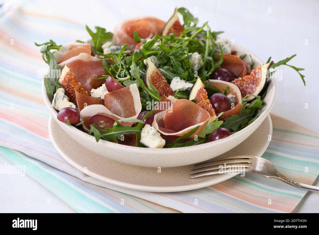 Arugula salad with Parma ham, blue cheese, figs, grapes Stock Photo Alamy