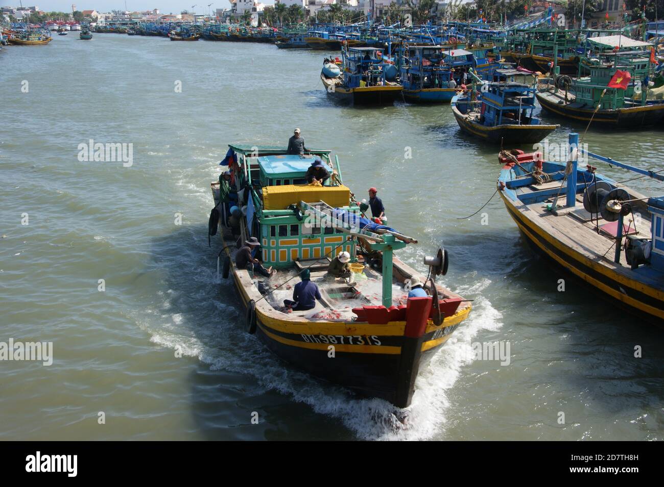 A Fishing family, leaving phan thiet harbour, prepares for a trip on the South China Seas. Stock Photo