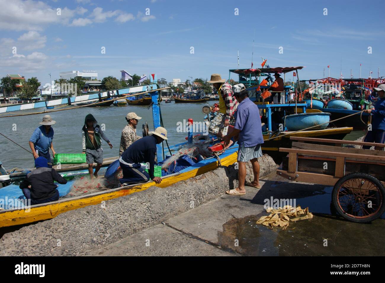 Fisermen preparing to unload a catch at the quayside of Phan Thiet's busy market. Stock Photo