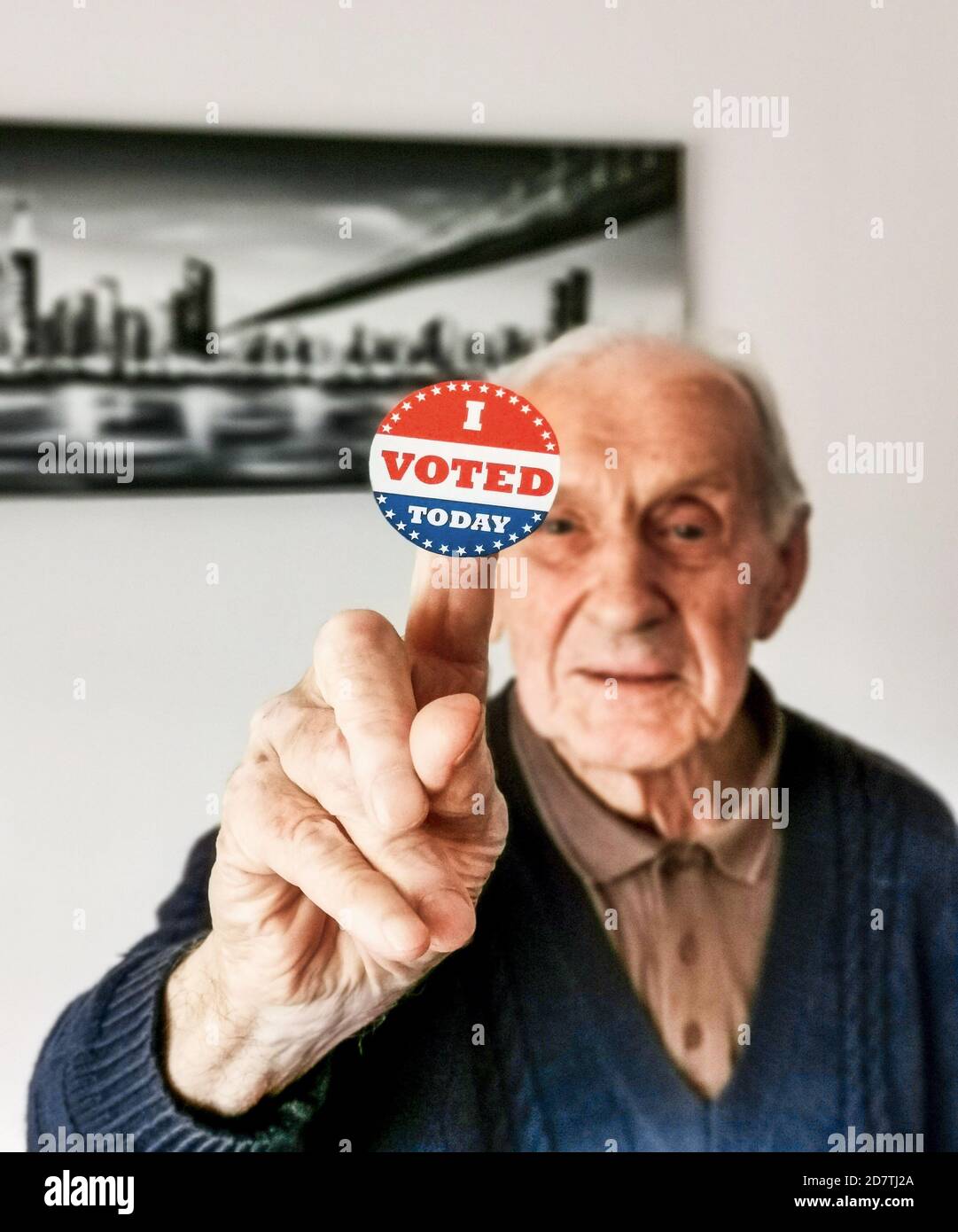 Old man holding a sign with the American flag colors with 'I voted