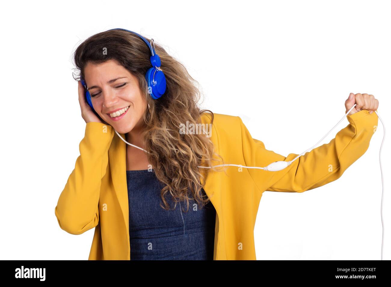Portrait of young beautiful woman listening to music with blue ...