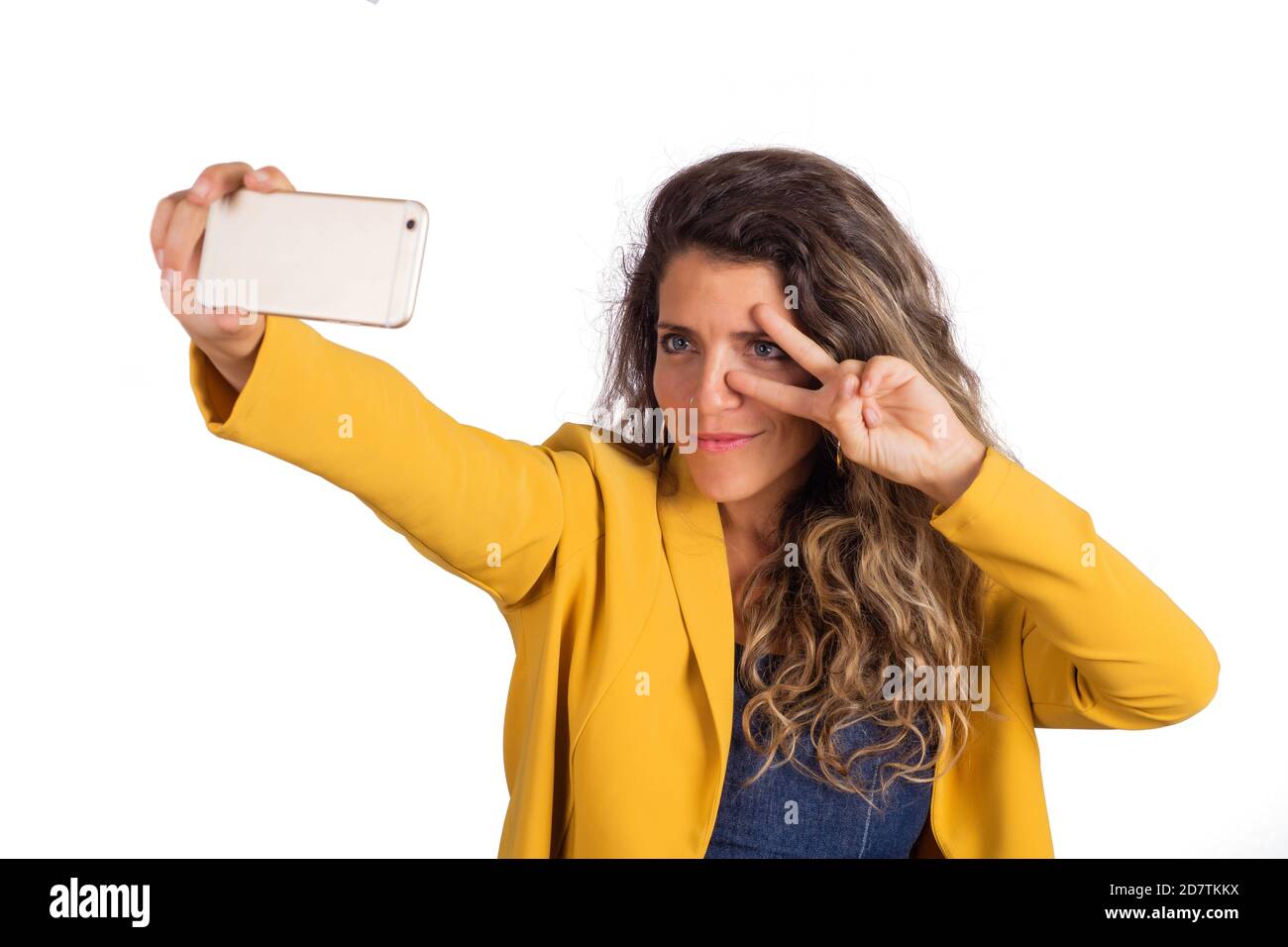 Portrait of young beautiful woman taking a selfie with her mobile phone ...