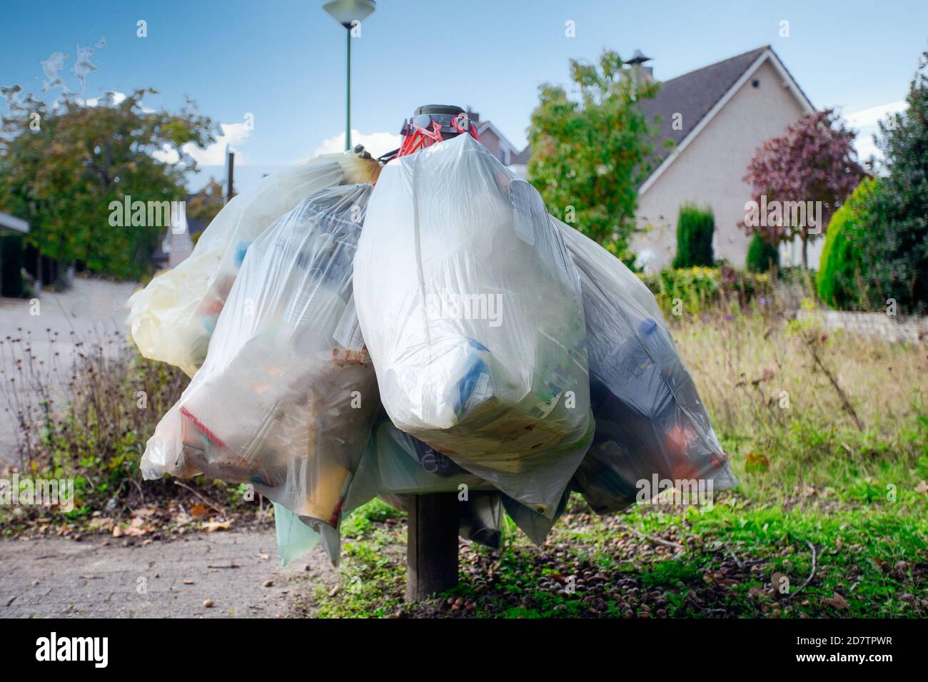 https://c8.alamy.com/comp/2D7TPWR/garbage-bag-for-plastic-hanging-in-the-street-for-pick-up-garbage-collector-waiting-to-destroy-recycle-and-environment-concept-2D7TPWR.jpg