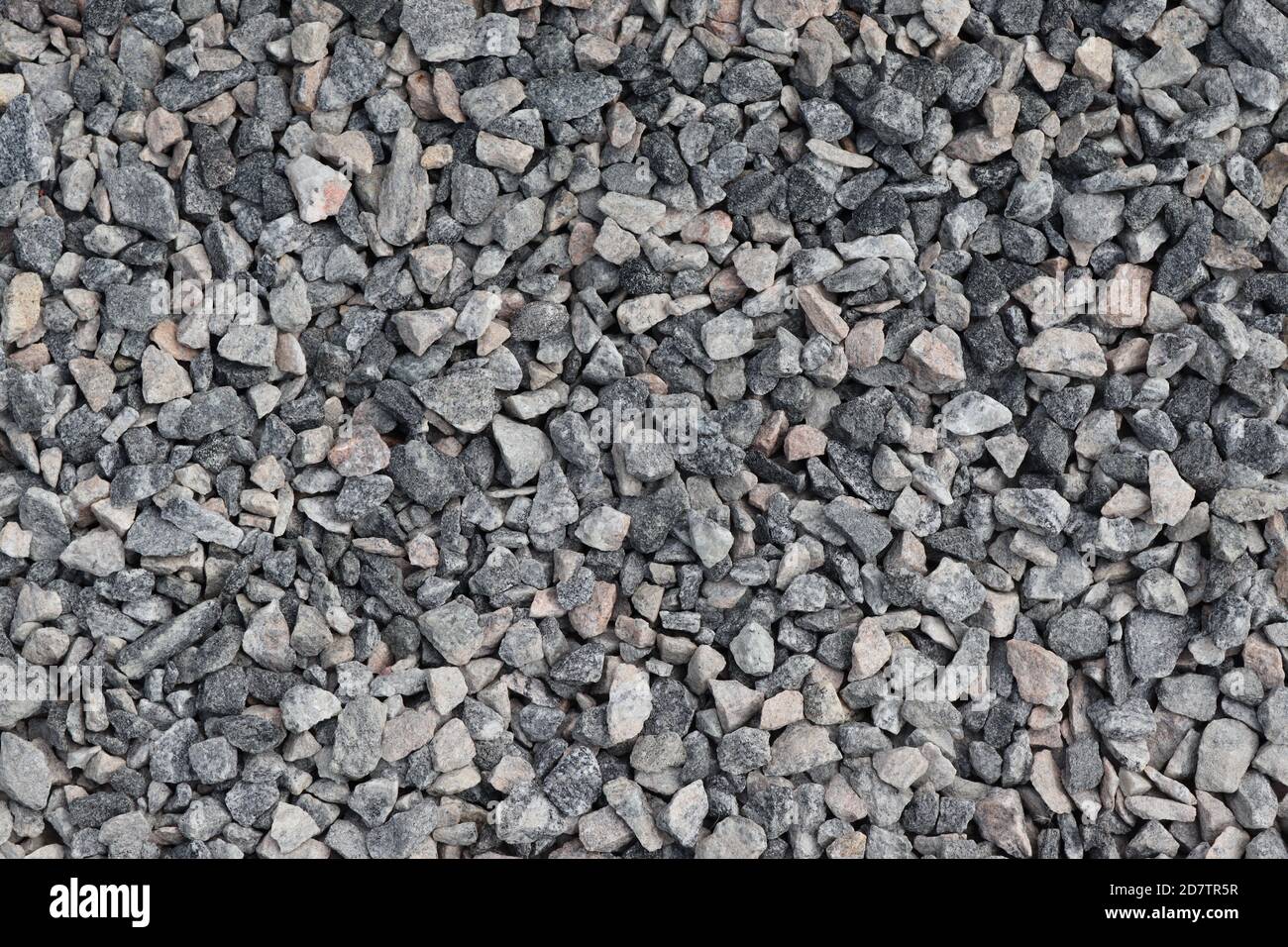 Pieces of black stones. Breaking from huge black rocks from the earth splitting in various sizes for various requirements. It is economy but nature? Stock Photo