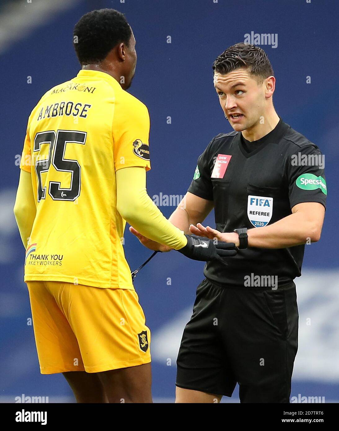 Referee Nick Walsh (right) speaks with Livingston's Efe Ambrose during the Scottish Premiership match at Ibrox Stadium, Glasgow. Stock Photo