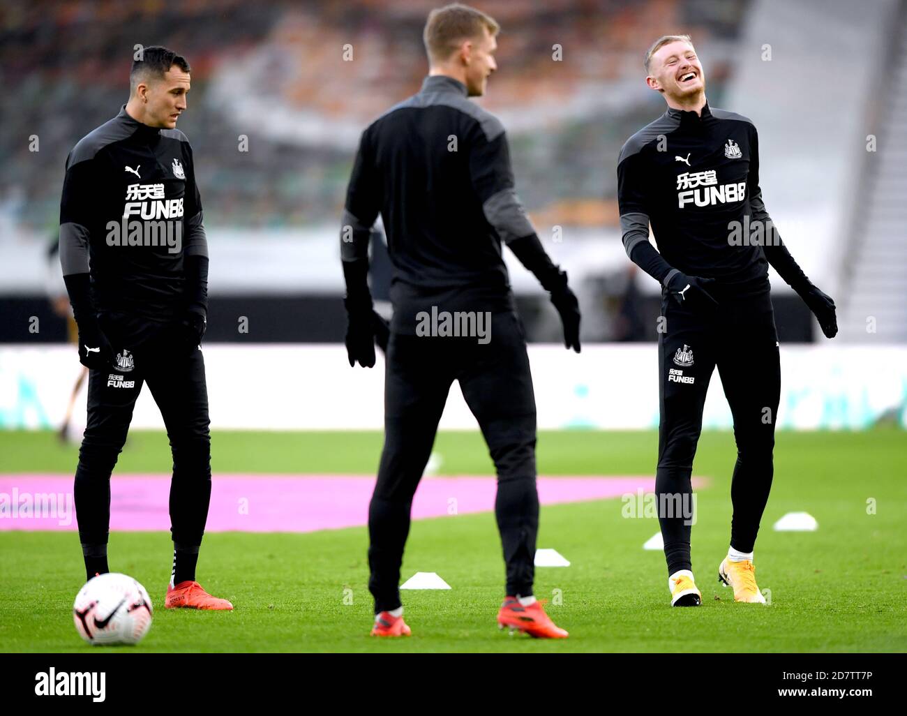 Newcastle United's Sean Longstaff (right) shares a joke with teammates as they warm up prior to the beginning of the Premier League match at Molineux, Wolverhampton. Stock Photo