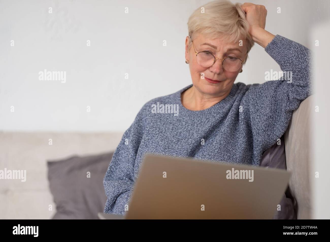 Mature woman working with laptop at home Stock Photo