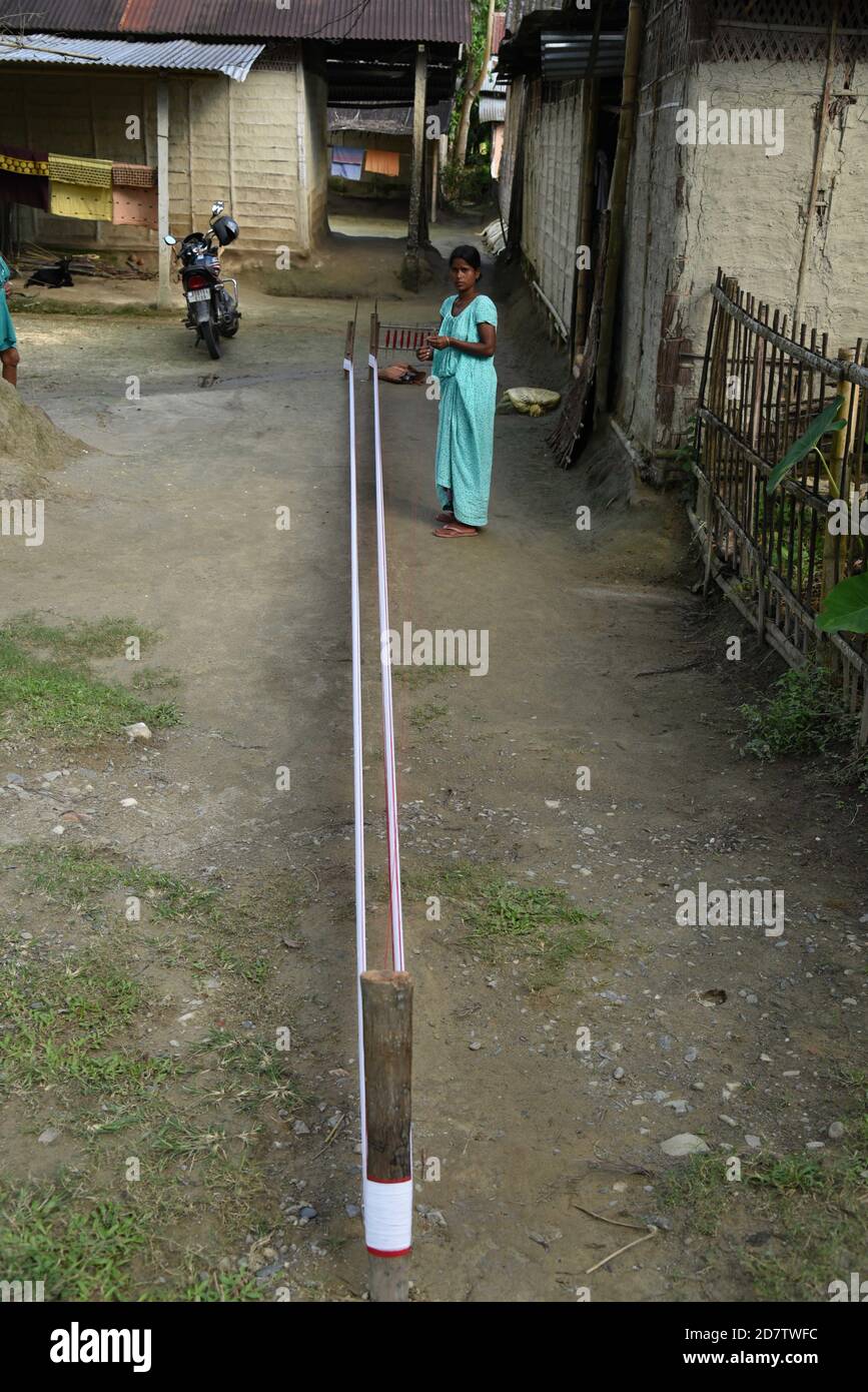 Guwahati, Assam, India. 25th Oct, 2020. An Assamese woman preparing to make traditional Assamese dress through Handloom weaving process at Angardhowa in Baksa district of Assam India on Sunday 25th October 2020. Credit: Dasarath Deka/ZUMA Wire/Alamy Live News Stock Photo