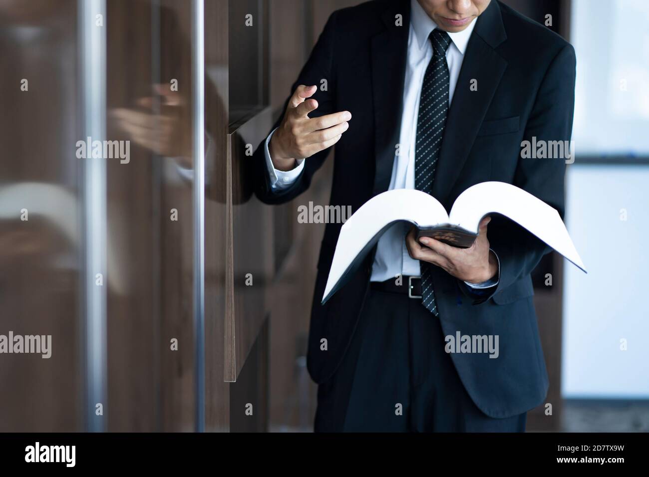 Cropped image of lawyer reading law book Stock Photo