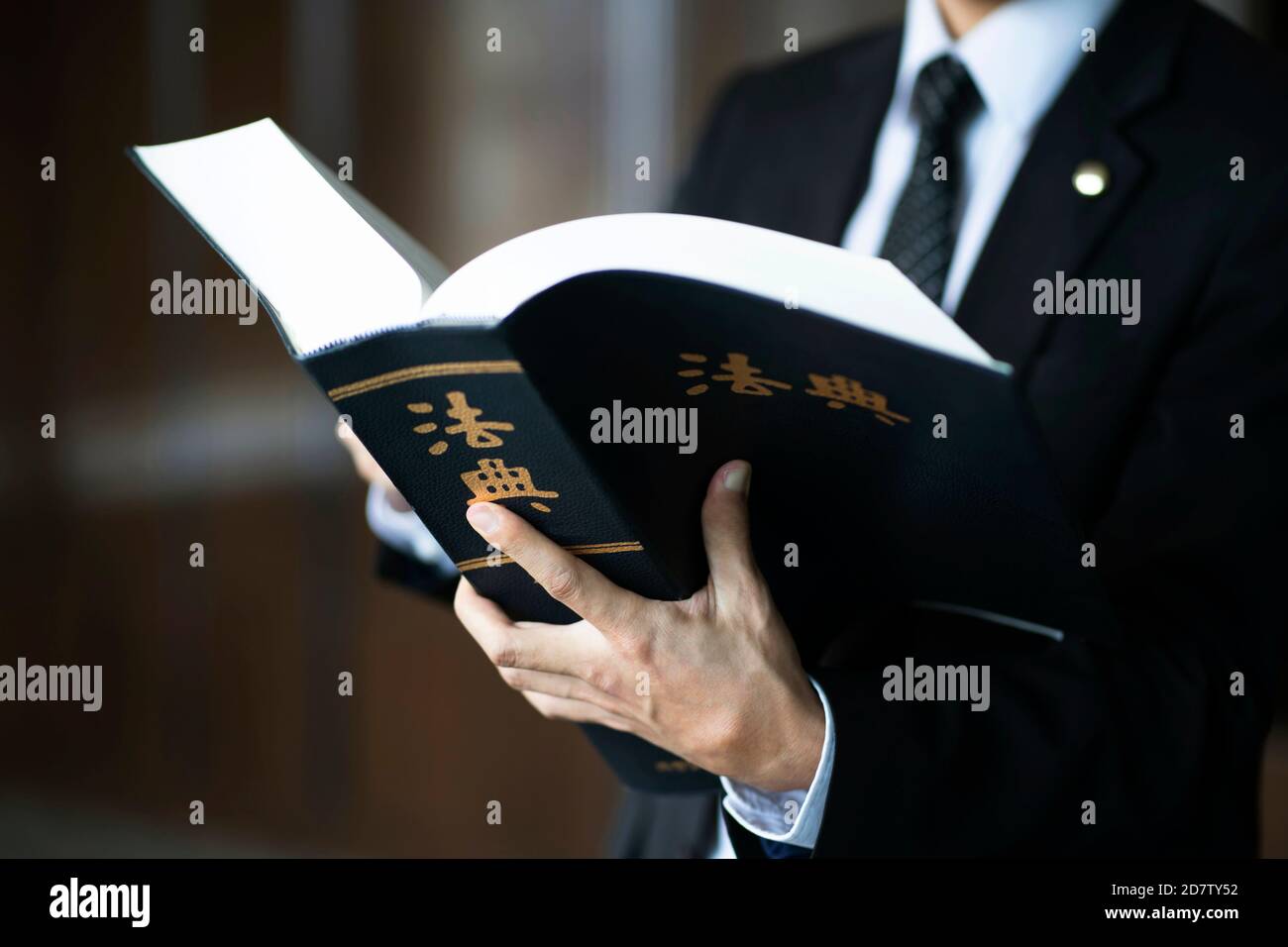 Lawyer holding code of law.Chinese character 'beobjeon' means code of