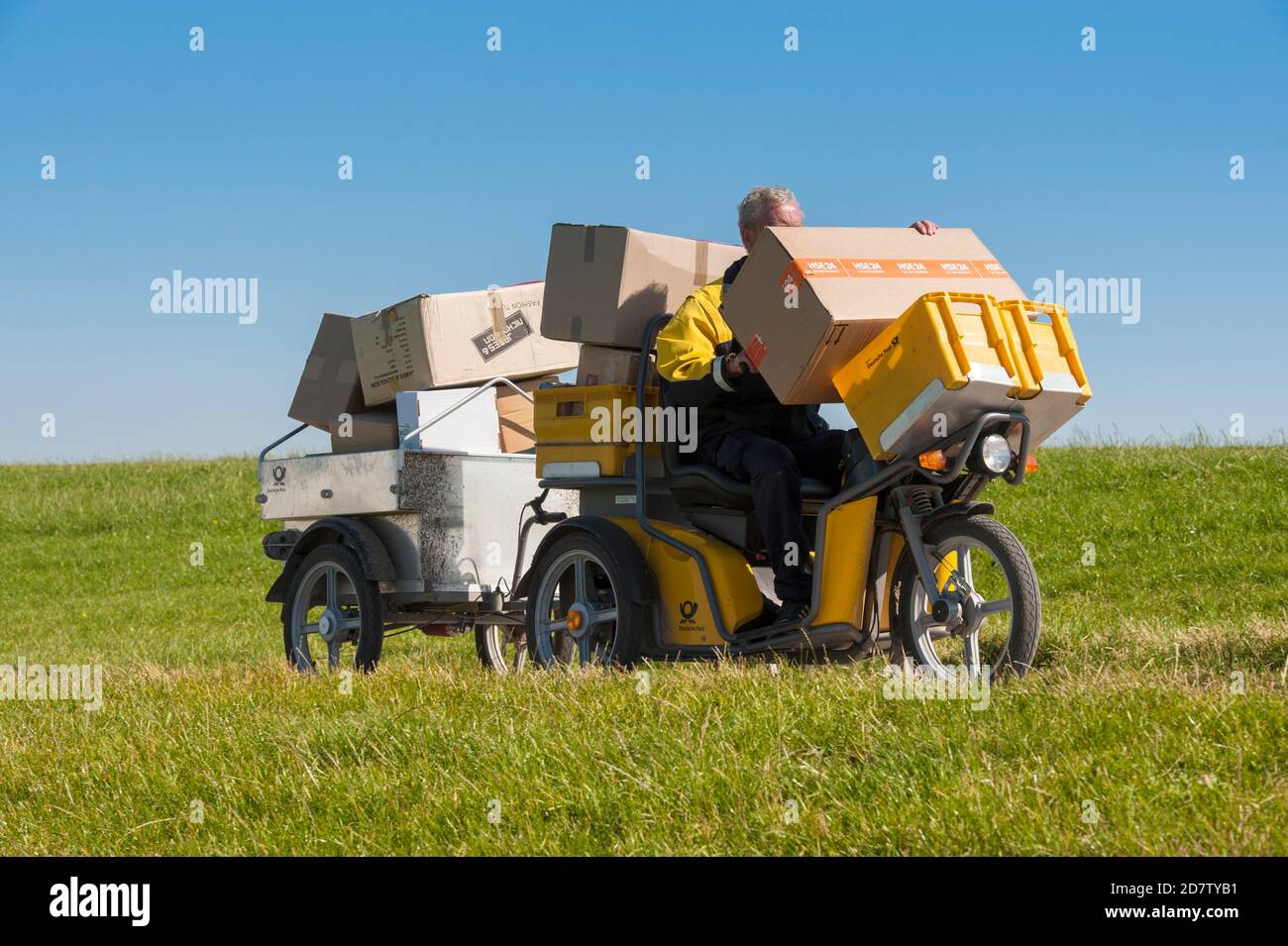 GERMANY, ISLAND NEUWERK,  Once a day the postman delivers the mail which arrived by ferry with an electric cart to the few inhabitants of t Stock Photo
