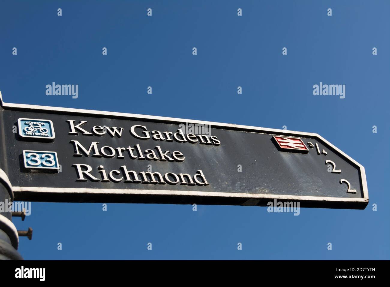 right pointing sign giving directions for kew gardens, mortlake and
