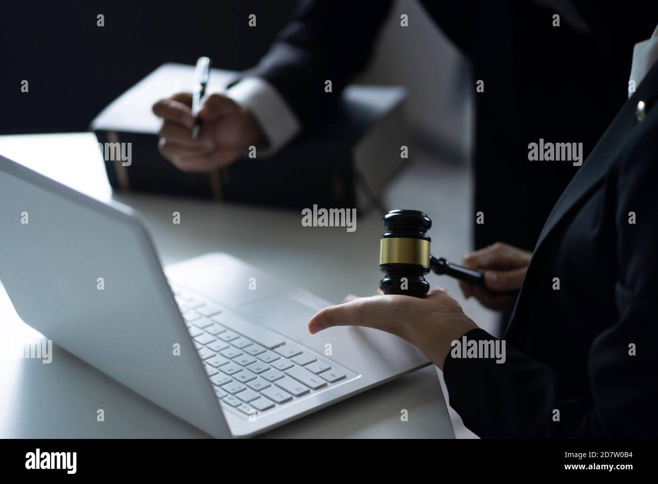 Lawyers  discussing with laptop at desk Stock Photo