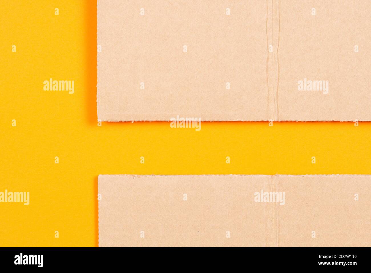 Brown blank cardboard with orange color paper background. Top view Stock Photo
