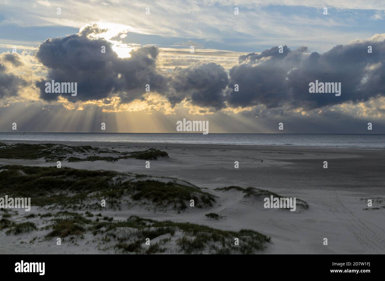 Amrum island, Germany: sun rays emerging through the dark storm clouds ...