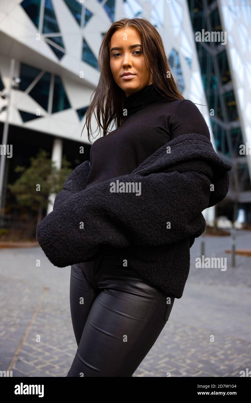 Environmental Portrait Of Attractive Young Woman In City Stock Photo