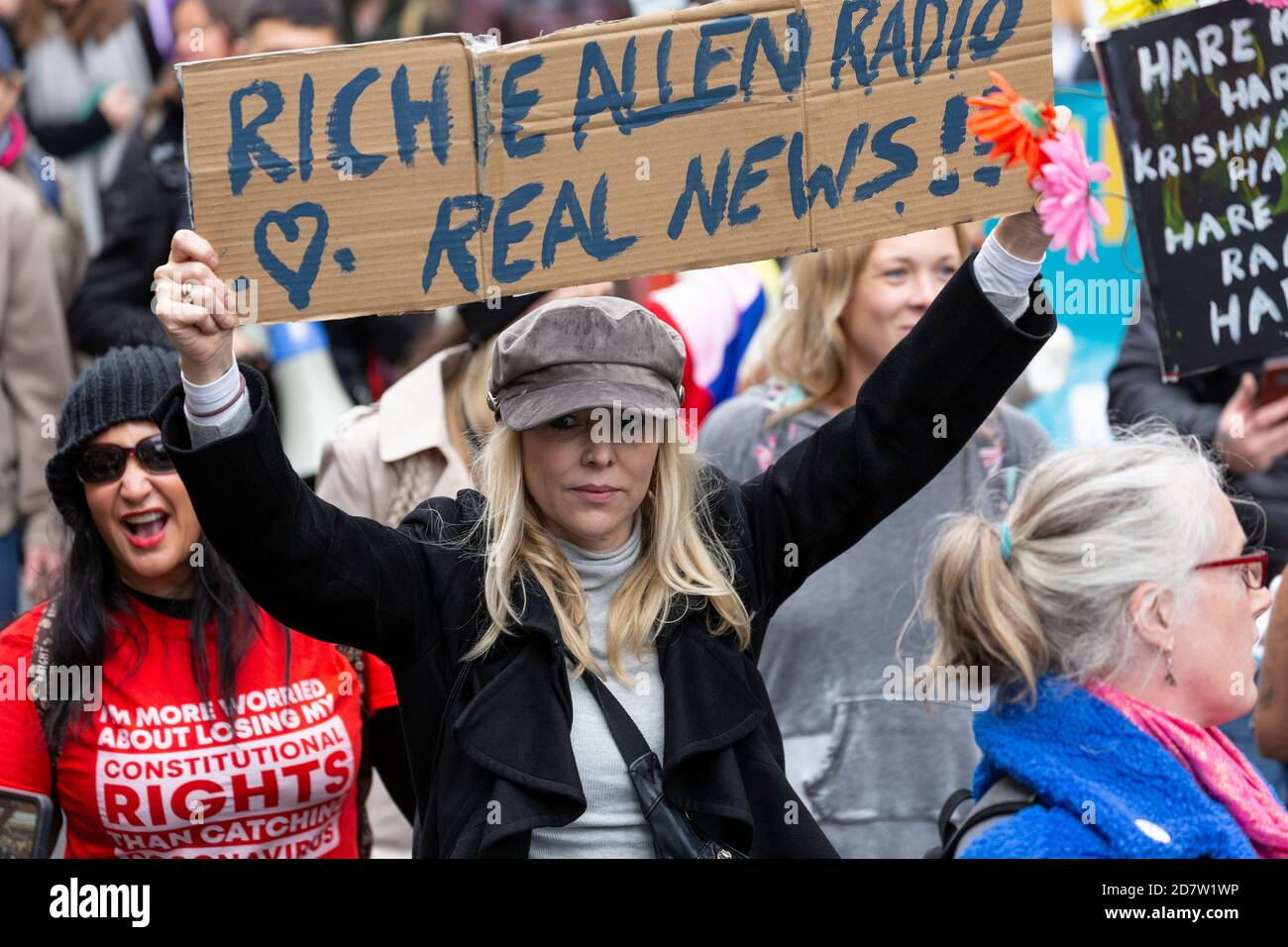A marching protester holds up a sign during an anti-lockdown rally in London, 24 October 2020 Stock Photo