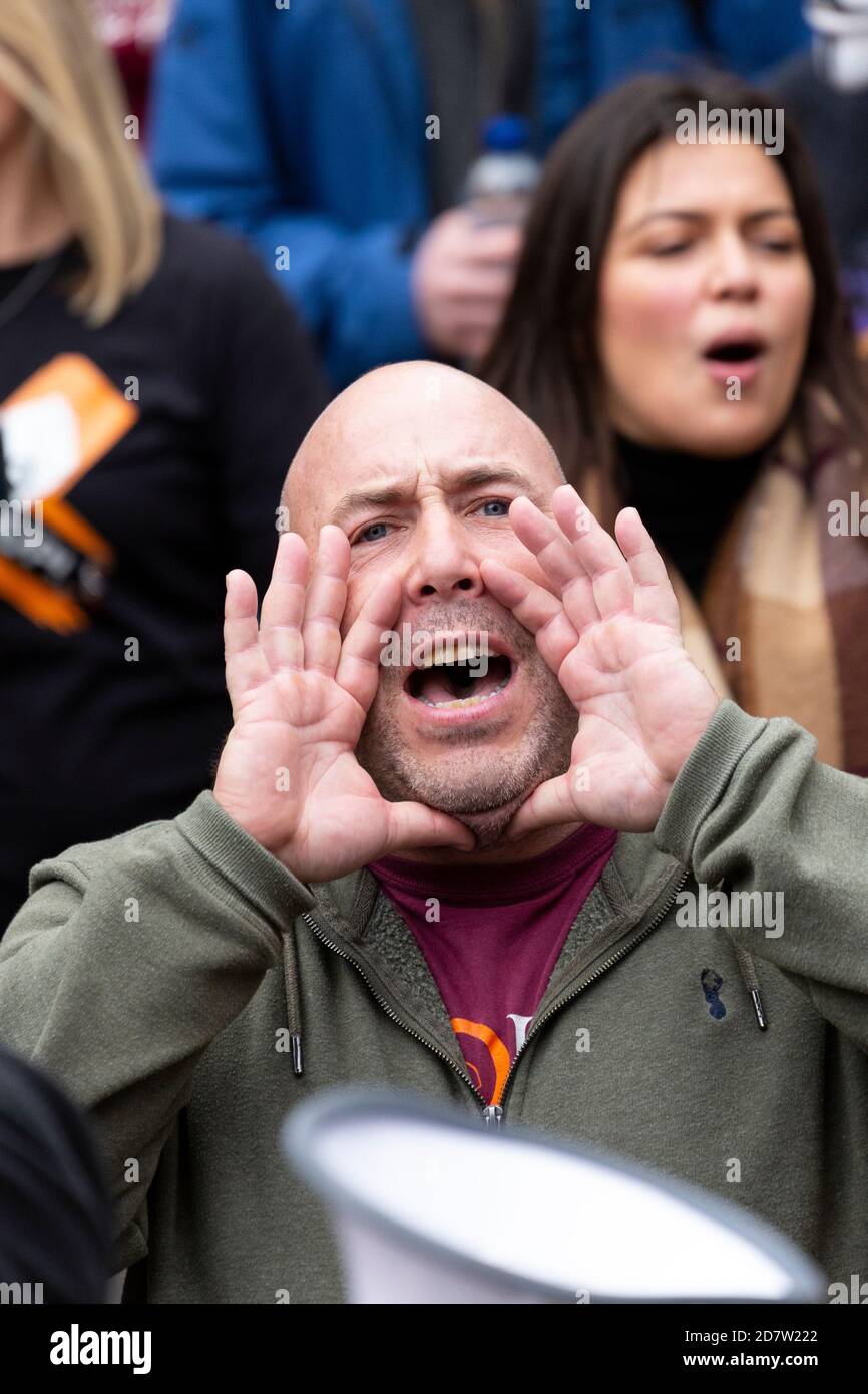 A man cups his hands and shouts during an anti-lockdown rally in London, 24 October 2020 Stock Photo