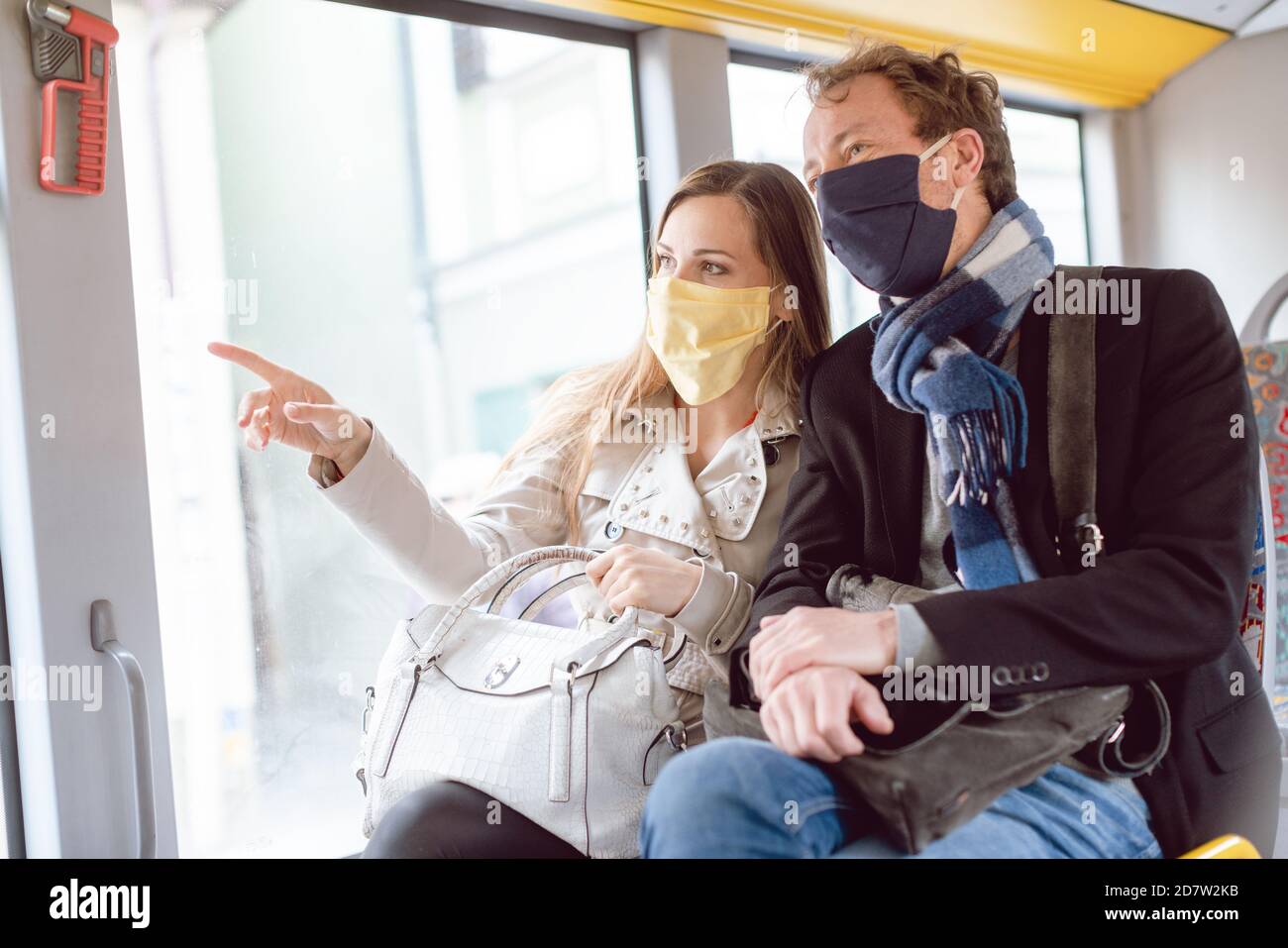 Couple in public transport bus wearing masks Stock Photo Alamy